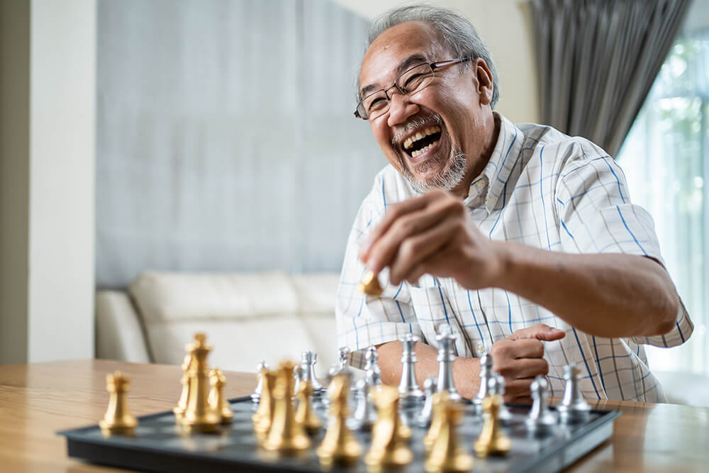 Happy gentleman playing chess